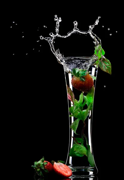 View of soft drink splashing out of glass on black back — Stock Photo, Image