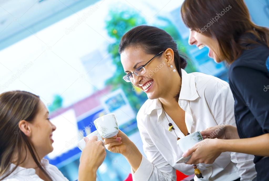 Portrait of young pretty women having coffee break in office environment