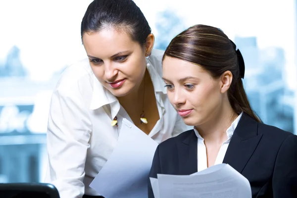 Portrait of young pretty women discussing project in office environment — Stock Photo, Image