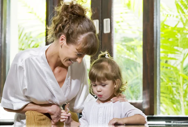 Portrait of beautiful young woman with her daughter — Stock Photo, Image