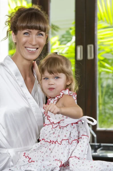 Portrait of beautiful young woman with her daughter — Stock Photo, Image