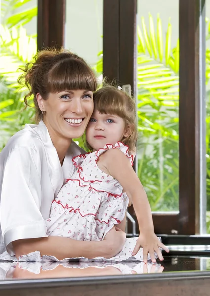 Portrait of beautiful young woman with her daughter — Stock Photo, Image