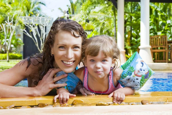 Portrait of beautiful young woman with her daughter — Stock Photo, Image