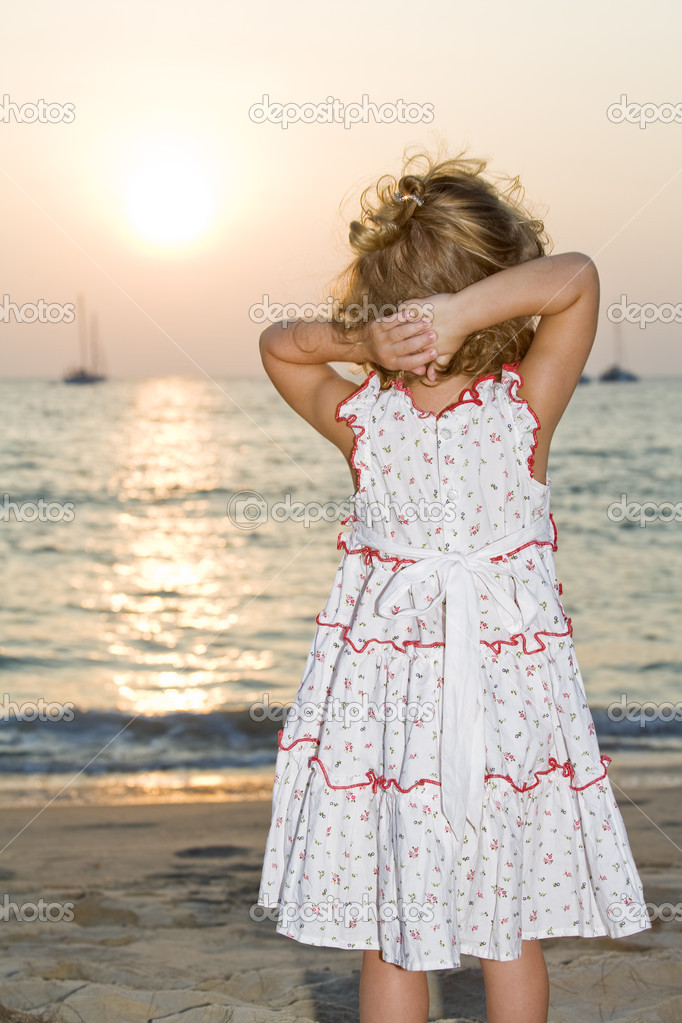 Portrait of little white girl having fun on the beach