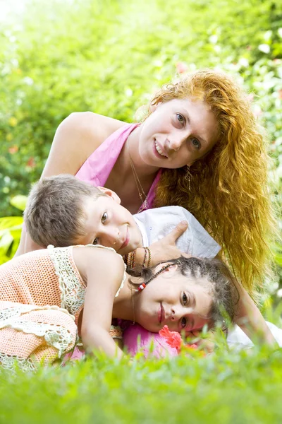 Portrait of little kids with mama having good time in summer environment — Stock Photo, Image