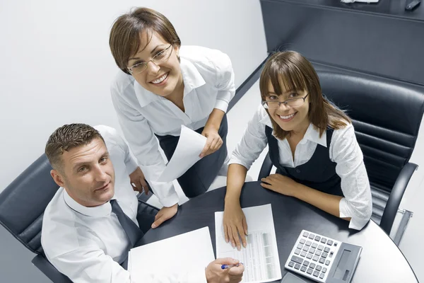 Portrait of young business discussing project in office environment — Stock Photo, Image