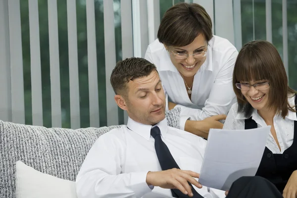 Portrait of young business discussing project in office environment — Stock Photo, Image