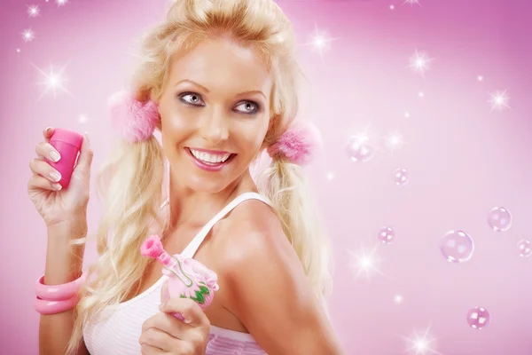 Portrait of young nice woman with soap bubbles on pink back — Stock Photo, Image