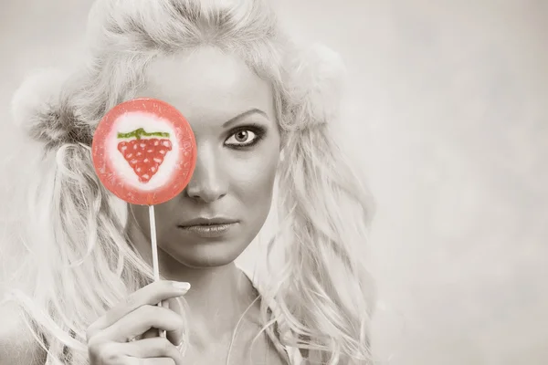 Portrait of young nice woman with lollypop on pink back — Stock Photo, Image