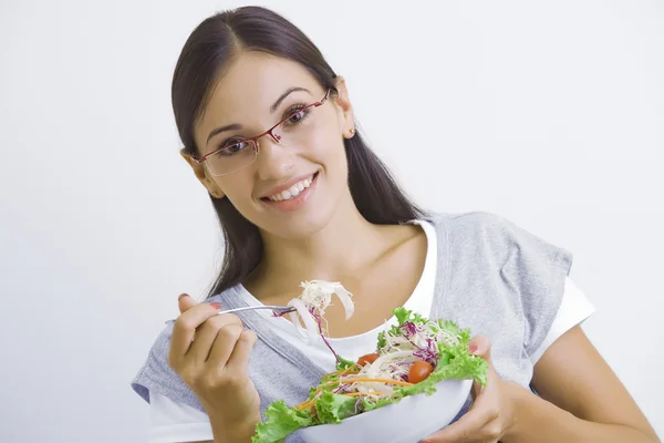 Portrait of young beautiful brunette with vegetable salad Stock Image