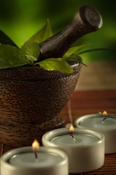 Close up view of candles, brown mortar with ingredients inside — Stock Photo, Image