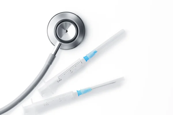 Close up view of white plastic syringe, stethoscope — Stock Photo, Image