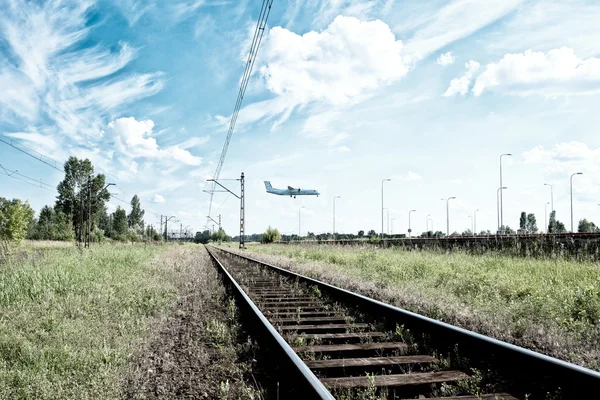 Railway and airplane in background — Stok fotoğraf