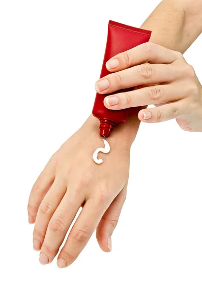 La crema sobre la mano femenina —  Fotos de Stock