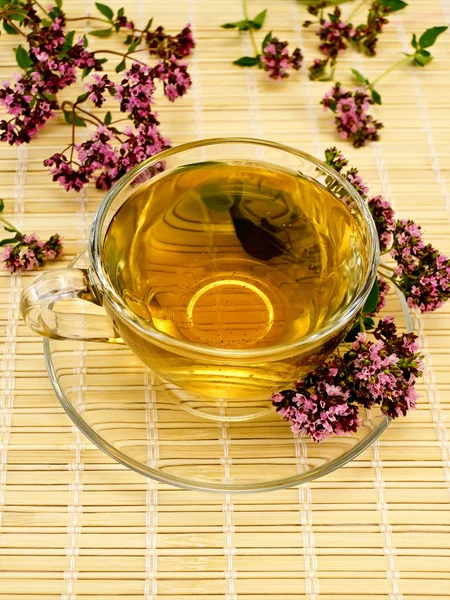 Herbal tea with oregano on bamboo — Stock Photo, Image