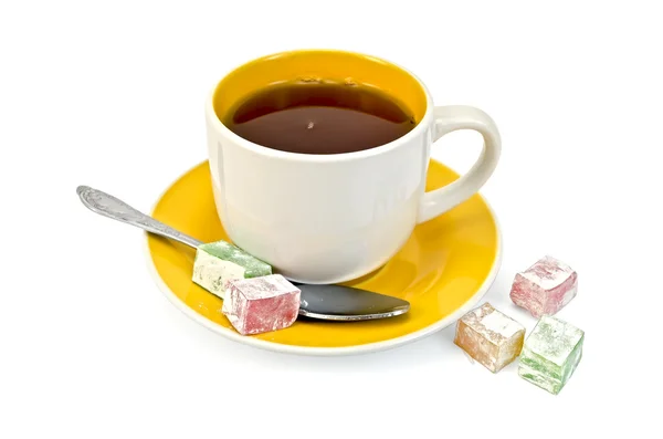 Tea in yellow cup with lokum — Stock Photo, Image