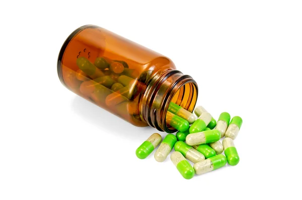 Capsules green in an open of brown jar — Stock Photo, Image