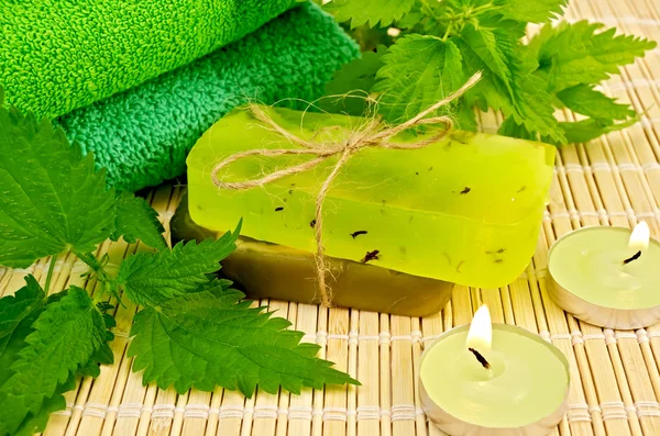 Soap green homemade with nettle and candles — Stock Photo, Image