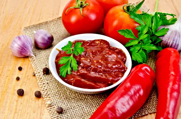 Ketchup with vegetables on a napkin burlap — Stock Photo, Image