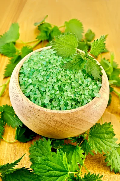 Salt green in a bowl with nettles on the board — Stock Photo, Image