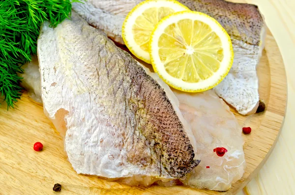 Fillet of codfish on a round board — Stock Photo, Image