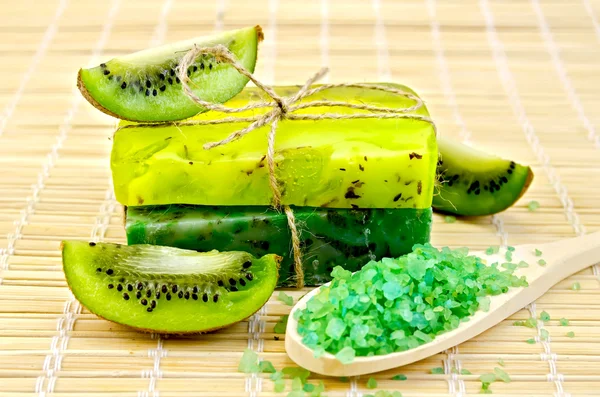 Soap homemade and salt in a spoon with kiwi — Stock Photo, Image