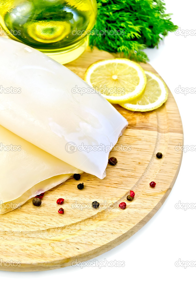 Squid with lemon and oil on a round board