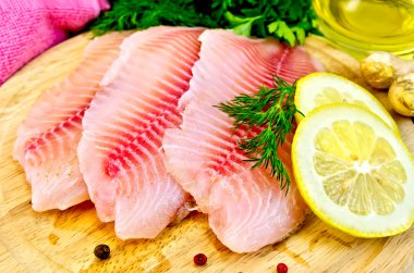 Fillets tilapia with oil and lemon clipart