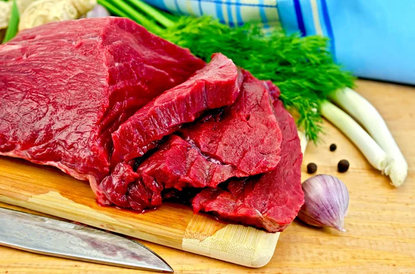 Meat beef on a wooden board with a knife — Stock Photo, Image