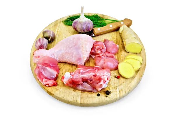 Chicken leg cut on a round board — Stock Photo, Image