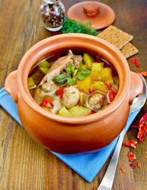 Roast chicken in a clay pot with hot pepper clipart