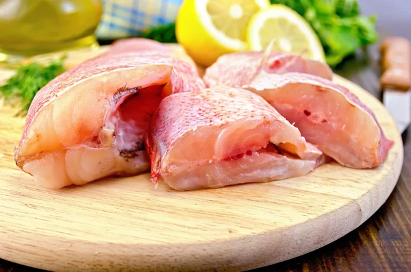 Fillet of sea bass with oil and a knife — Stock Photo, Image