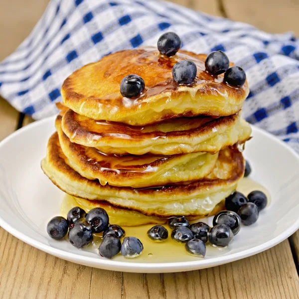 Flapjacks with blueberries and honey on the board — Stock Photo, Image