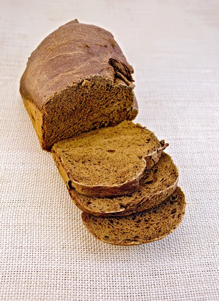 Rye homemade bread on rough bagging — Stock Photo, Image