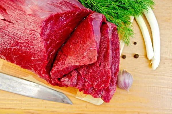 Meat beef on a board with garlic — Stock Photo, Image