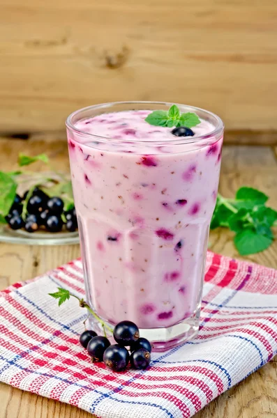 Milk cocktail with black currants on the board — Stock Photo, Image