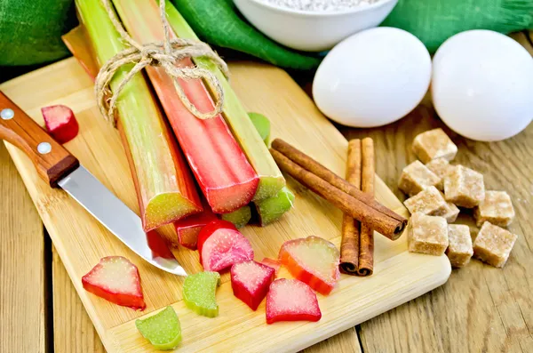Rhubarb with sugar and eggs on the board — Stock Photo, Image