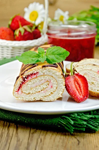 Roulade with a jar of jam and strawberries on a board — Stock Photo, Image