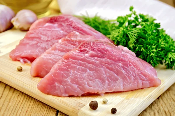 Meat pork slices on a board — Stock Photo, Image