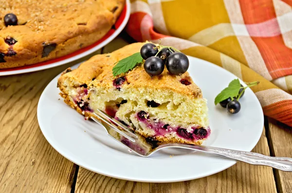 Pie with black currant on the board with a fork — Stock Photo, Image