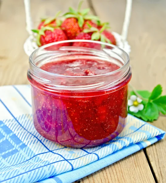 Jam of strawberry with a basket on the board — Stock Photo, Image