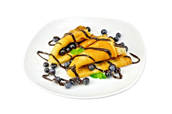 Pancakes with blueberries and chocolate in a plate — Stock Photo, Image