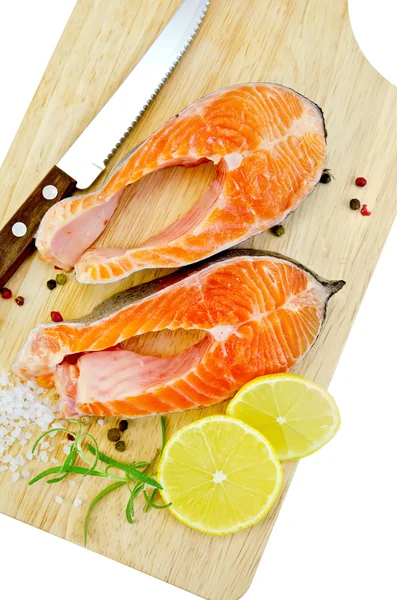 Trout with lemon and knife on plank — Stock Photo, Image