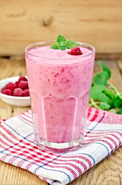 Milkshake with raspberries on board — Stock Photo, Image