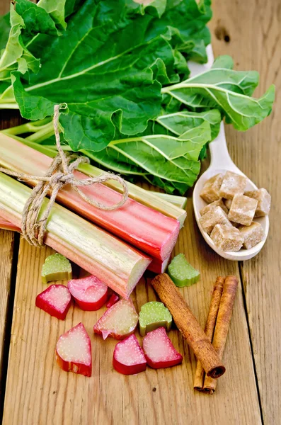 Rhubarb on board with sugar and cinnamon — Stock Photo, Image