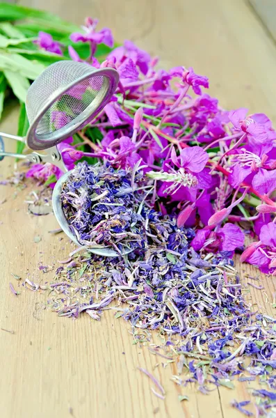 Herbal tea with strainer of fireweed on board — Stock Photo, Image