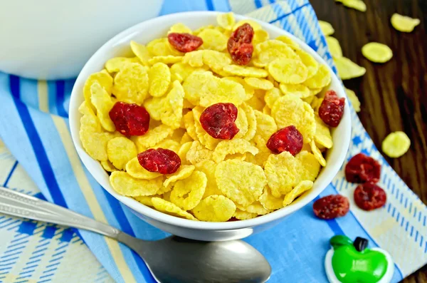 Cornflakes with dried cherries and milk on board — Stock Photo, Image