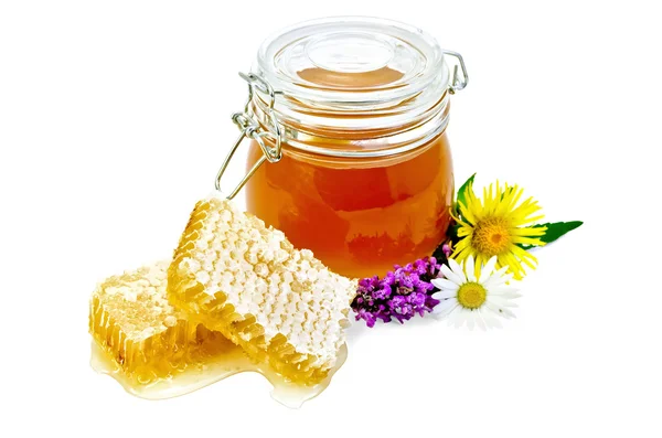 Honeycomb with a jar and flowers — Stock Photo, Image