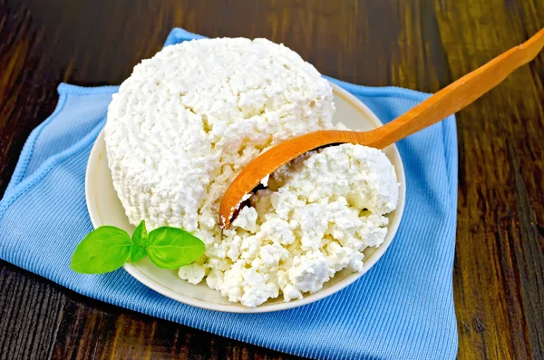 Curd with a wooden spoon on board — Stock Photo, Image