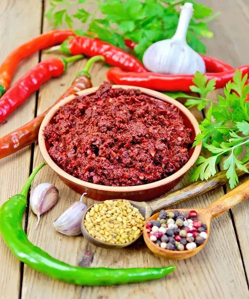 Adjika with hot pepper and spices on board — Stock Photo, Image